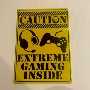 Caution extreme gaming inside metal sign.